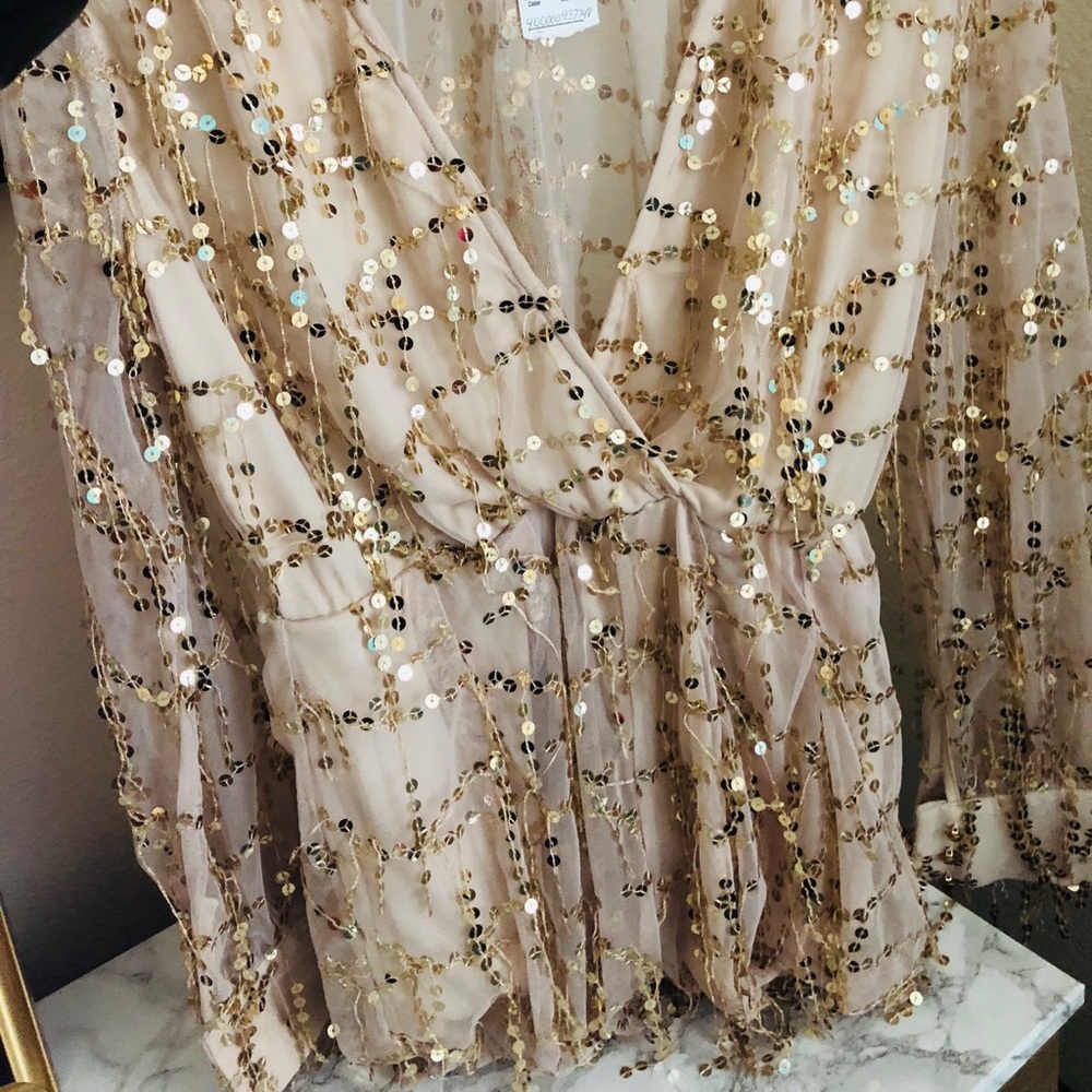 Gold Sequences for days on this long sleeve romper